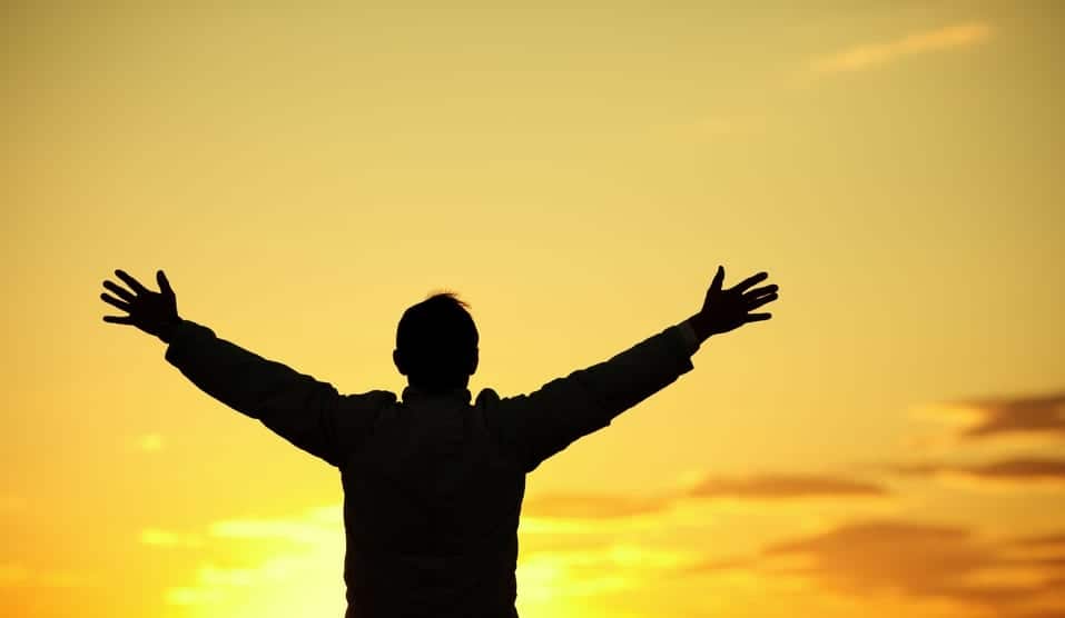 Man with hands outstretched symbolizing freedom from addiction